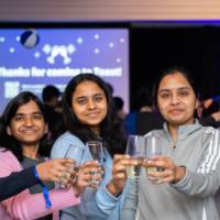 Group of grads cheers together at Toast